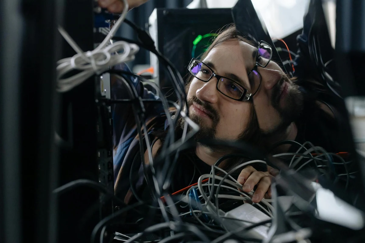 Exicomm technician performing in-home diagnostics on electronics equipment